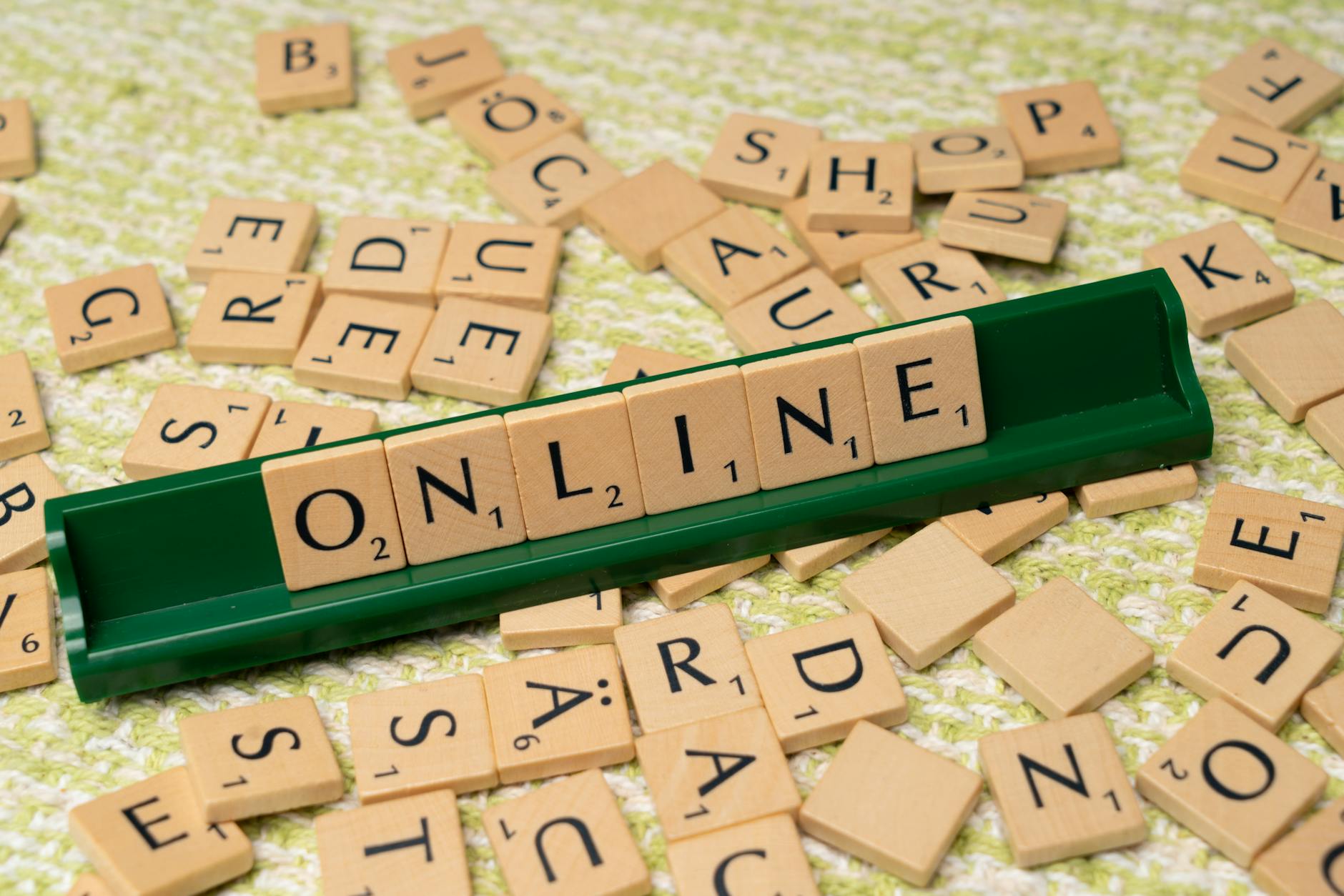 https://www.pexels.com/photo/the-word-online-is-spelled-out-with-scrabble-tiles-18512823/